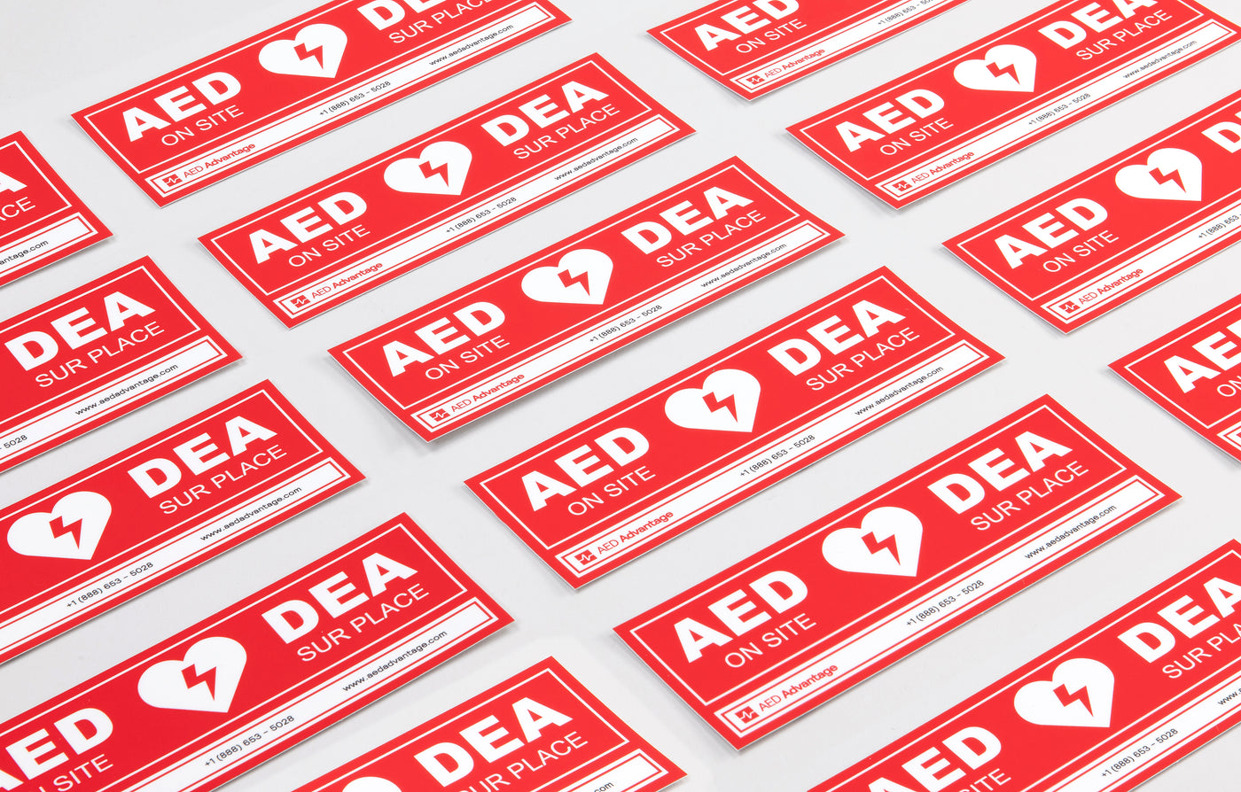 A collage of red rectangular decals that adhere to doors indicating an AED is present at a facility