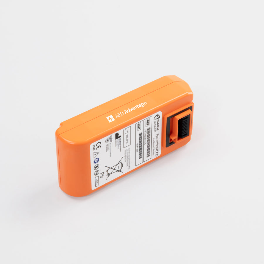 A bright orange rectangular battery pack for the Powerheart G5 defibrillator