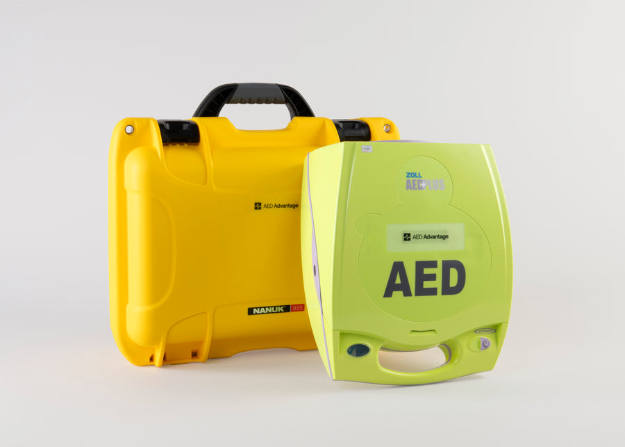 A bright green ZOLL Plus AED standing in front of a bright yellow hard carry case