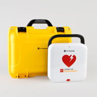 A white and red LIFEPAK CR2 AED machine and a bright yellow hardshell carry case