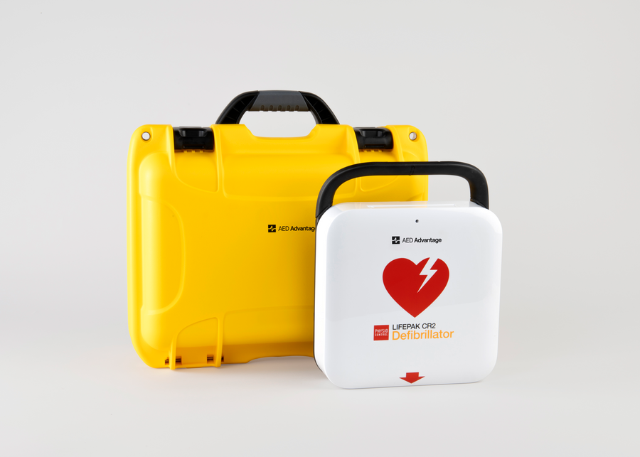 A white and red LIFEPAK CR2 AED machine and a bright yellow hardshell carry case