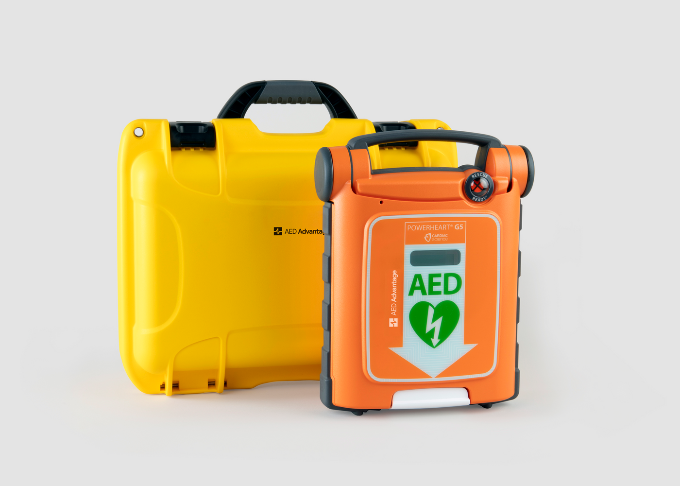 An orange Powerheart G5 AED standing next to a bright yellow hardshell carry case