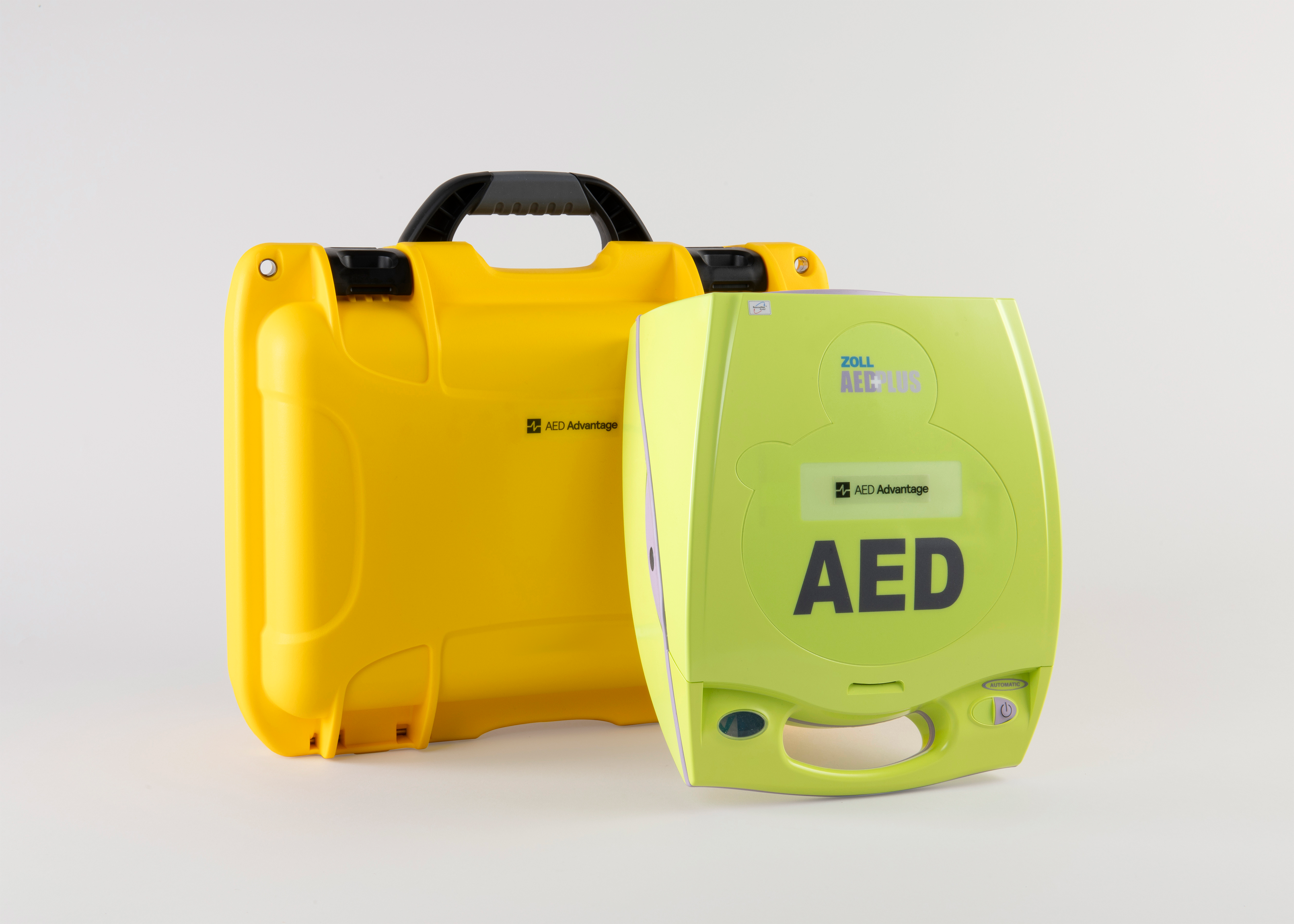 A green ZOLL AED 3 machine standing next to a bright yellow hardshell carry case