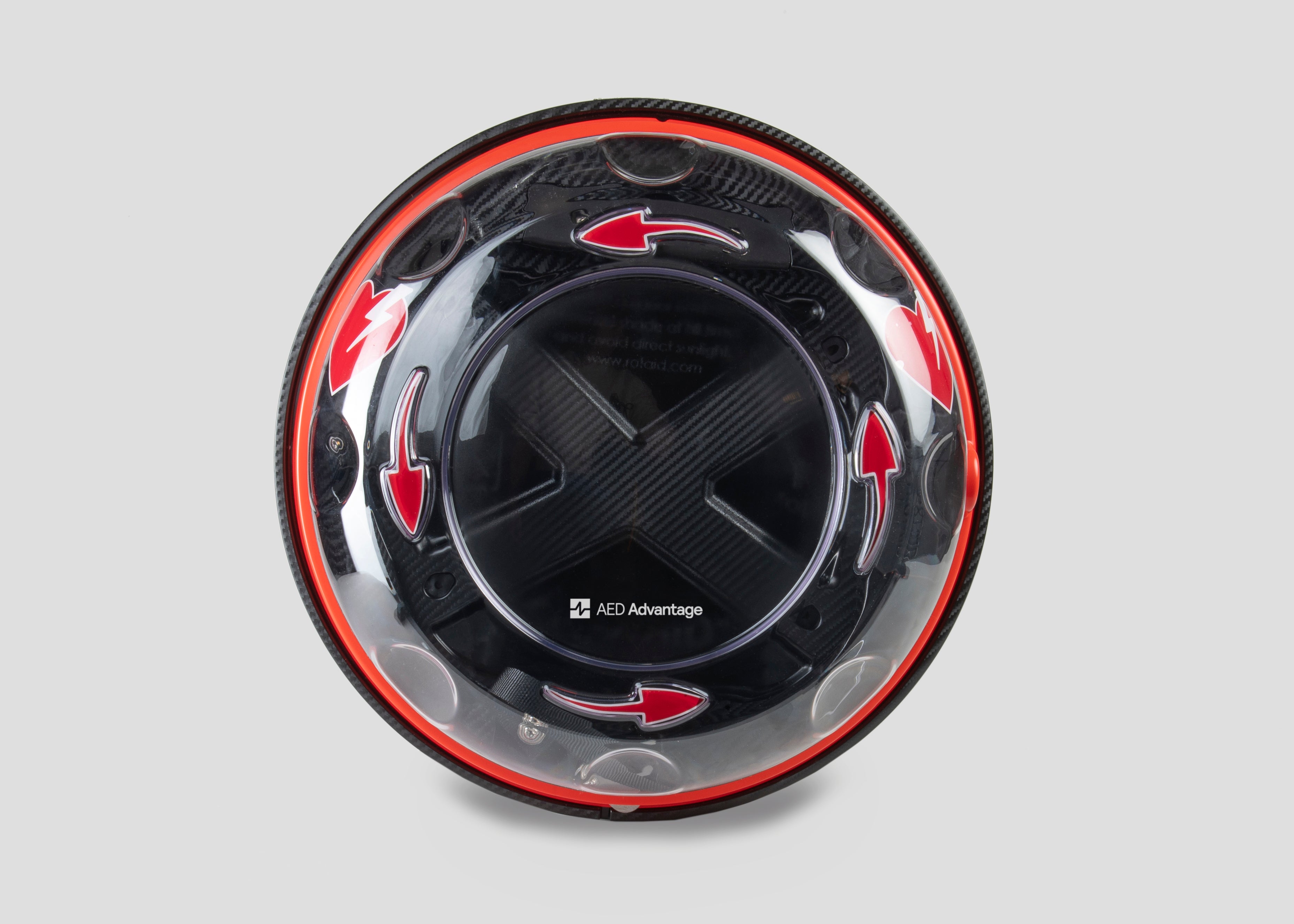 A black and yellow, spherical defibrillator cabinet with red arrows indicating which way to turn the lid to open it