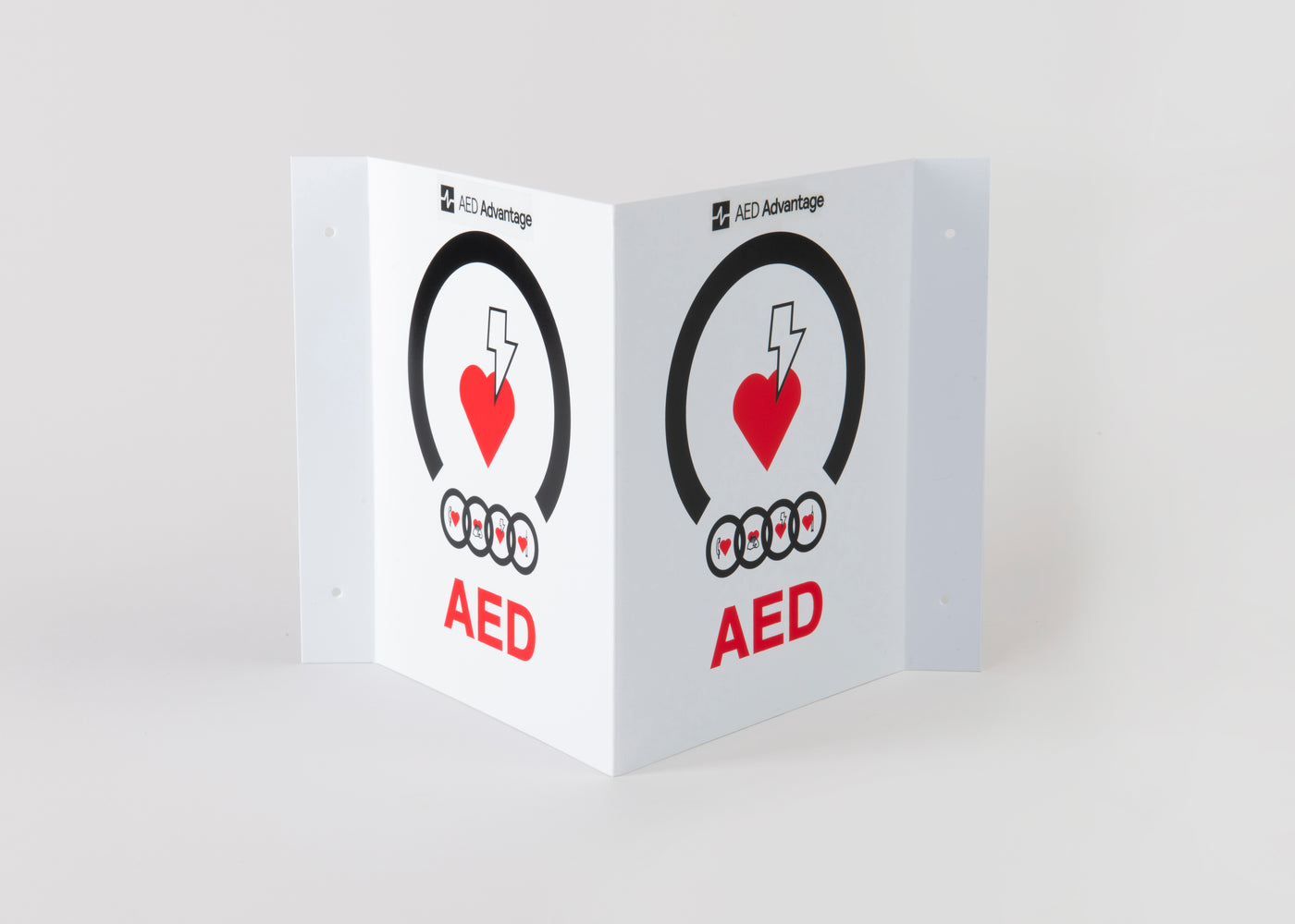 A tent-shaped 3D plastic wall sign that marks an AED is present to individuals approaching from any direction