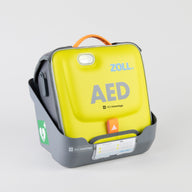 A gray wall mount bracket holding a bright green ZOLL AED 3