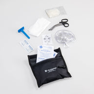 A black velcro pouch with its contents splayed out. Scissors, gloves, a razor, and facemask. 