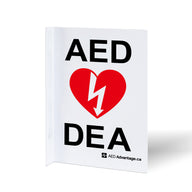 A bilingual white metal rectangular wall sign containing large bold text indicating an AED is present 