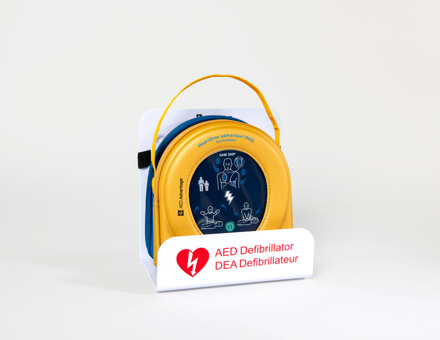 A HeartSine 500P AED in its yellow carry case displayed in a white wall mount bracket