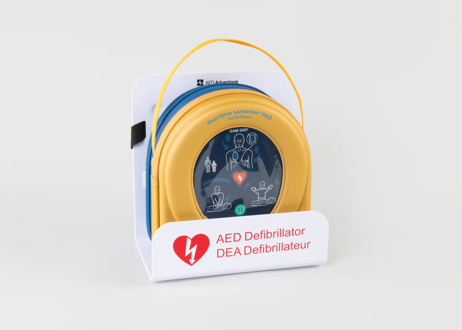 A HeartSine 500P AED in its yellow carry case displayed in a white wall mount bracket