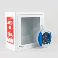 A blue and white HeartSine 500P AED standing in front of a white metal cabinet with red decals