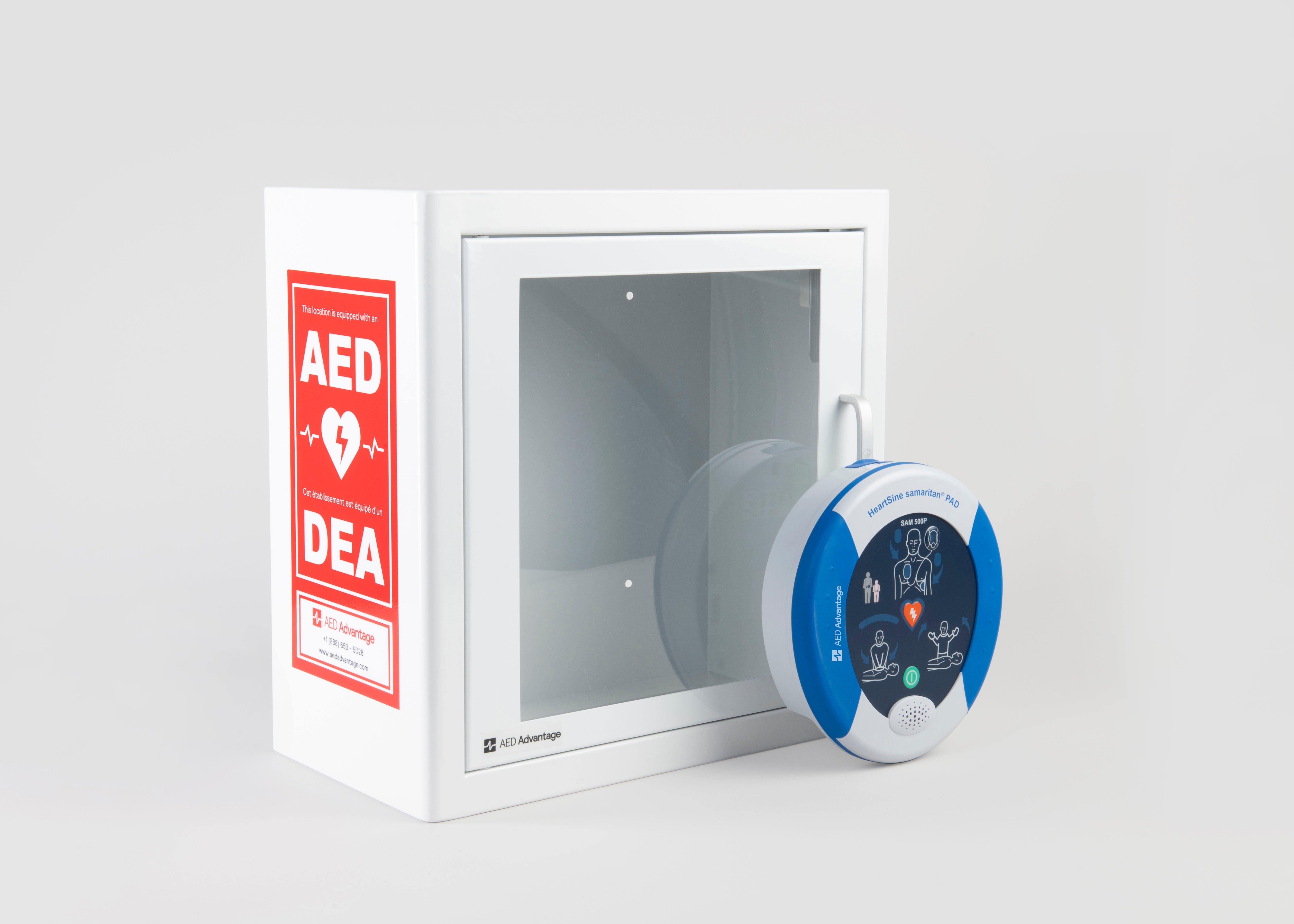 A blue and white HeartSine 500P AED standing in front of a white metal cabinet with red decals