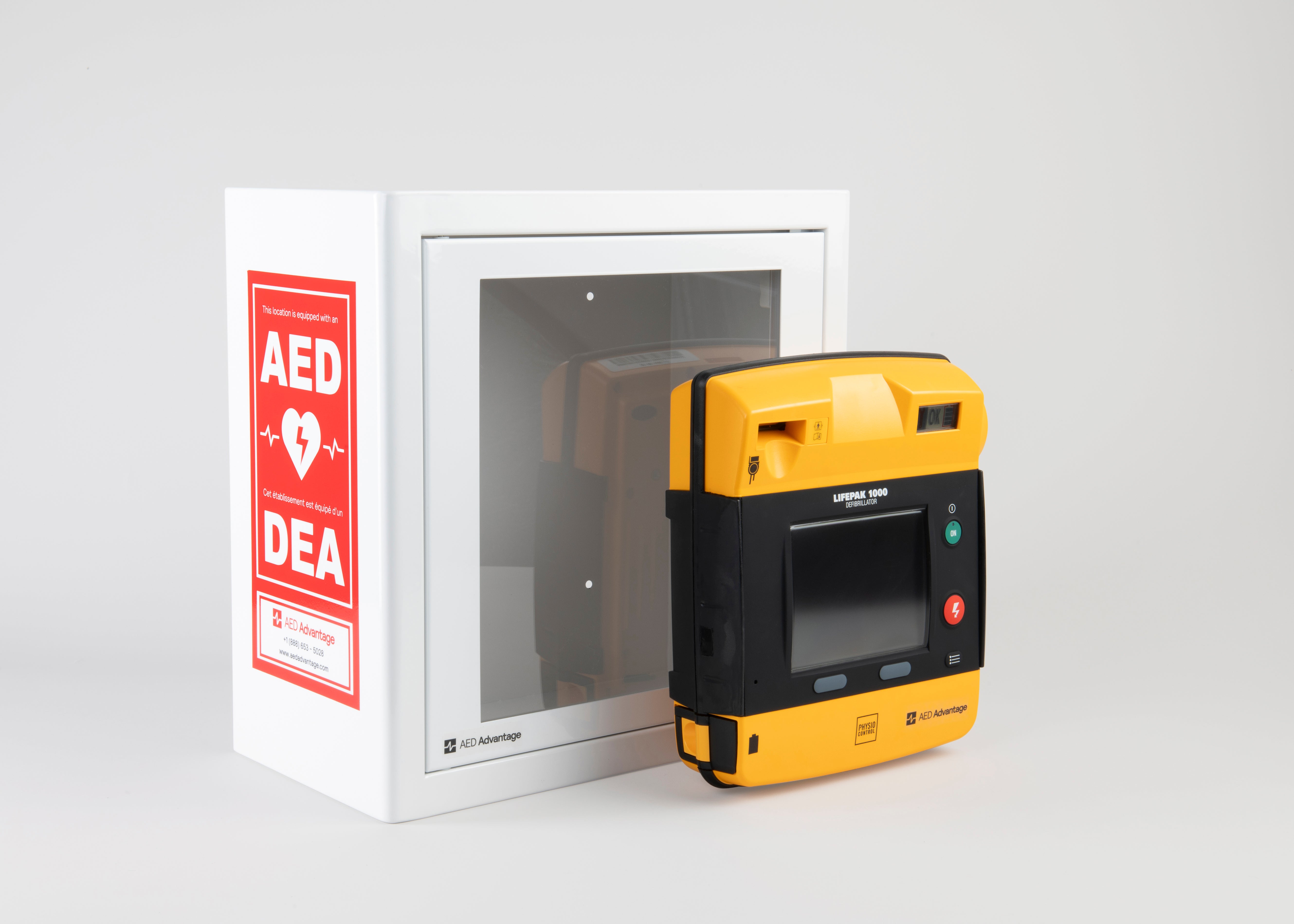 A black and yellow LIFEPAK 1000 AED standing in front of a white metal cabinet with red decals