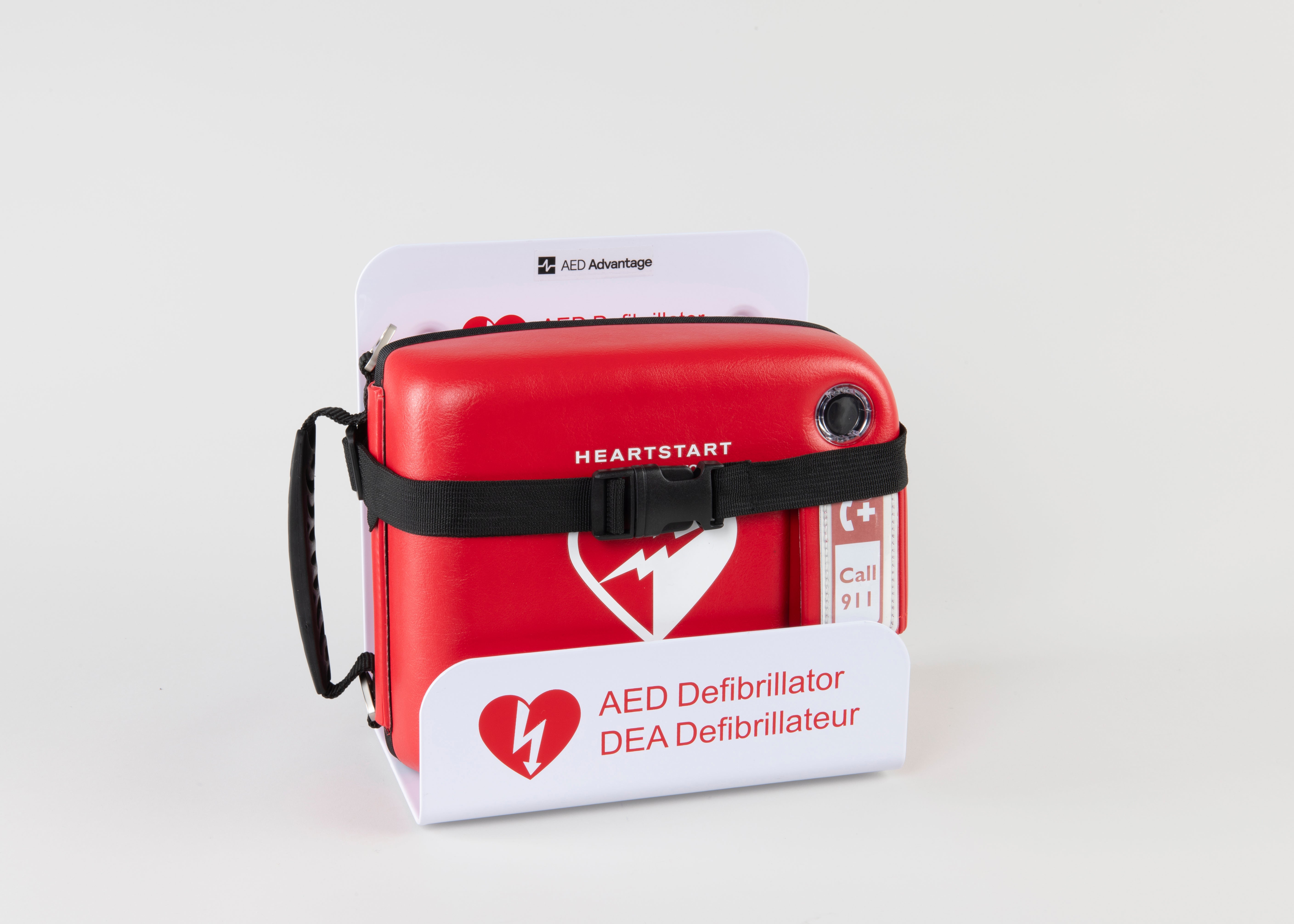 A Philips FRx AED in a bright red carry case strapped into a white metal wall mount bracket