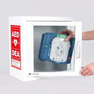 A blue Philips OnSite AED being retrieved by hand from a white metal cabinet with red decals