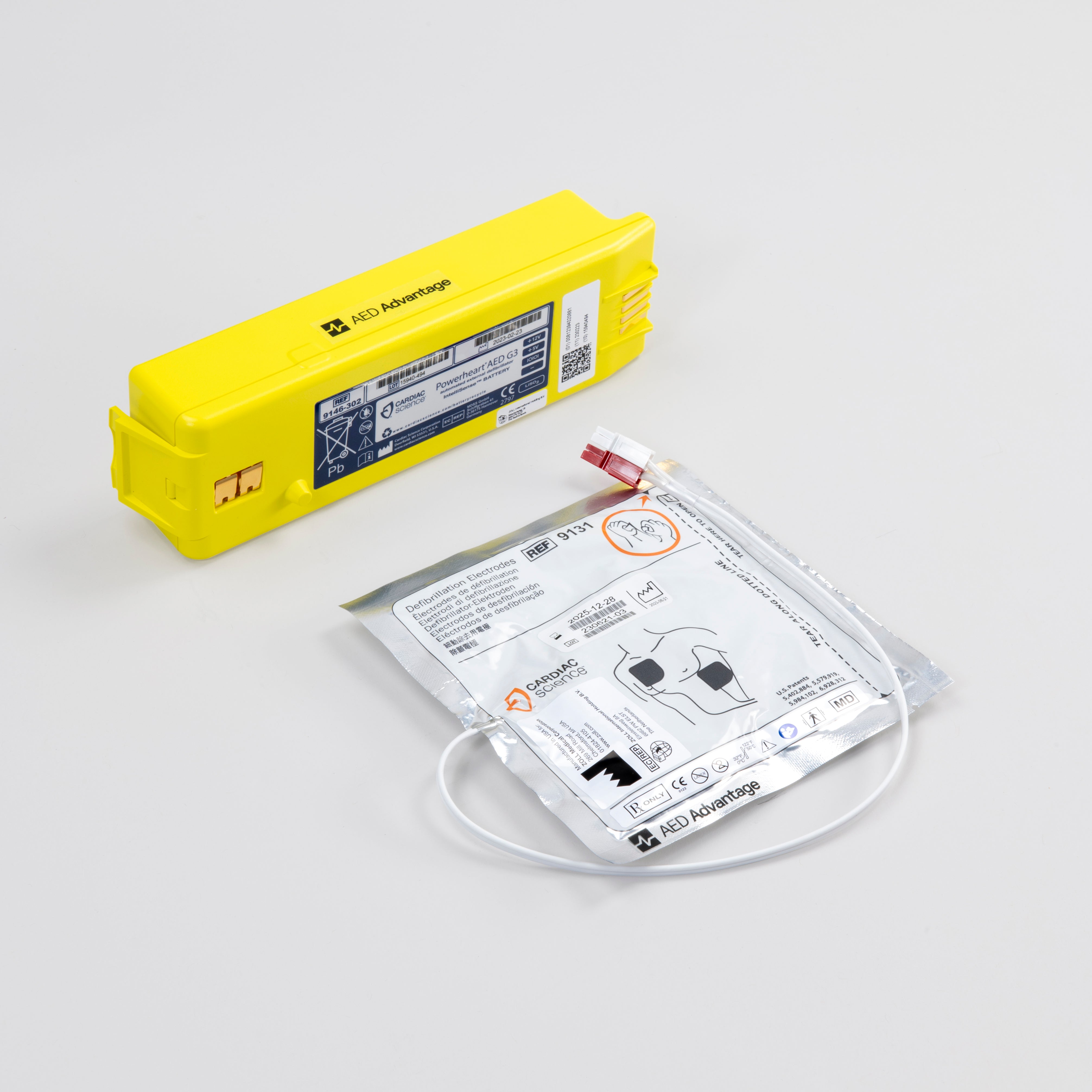 White electrodes package and bright yellow battery pack for the Powerheart G3 defibrillator