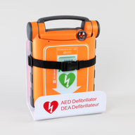 An orange Powerheart G5 AED strapped into a white metal wall mount bracket