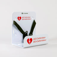 A white universal AED wall mount bracket with black straps and red signage