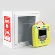 A green ZOLL AED 3 machine standing in front of a white metal cabinet with red decals