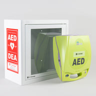 A green ZOLL AED Plus machine standing in front of a white metal cabinet with red decals