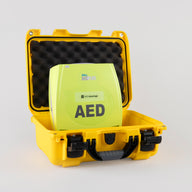 A green ZOLL AED Plus machine inside a bright yellow hardshell carry case