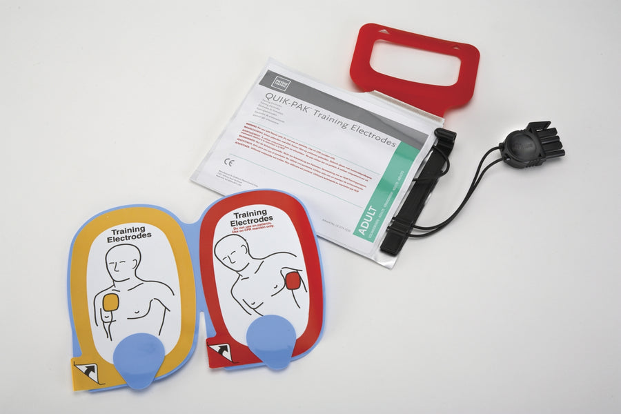 A white foil pouch and its contents which are colorful training electrodes for the CR Plus AED